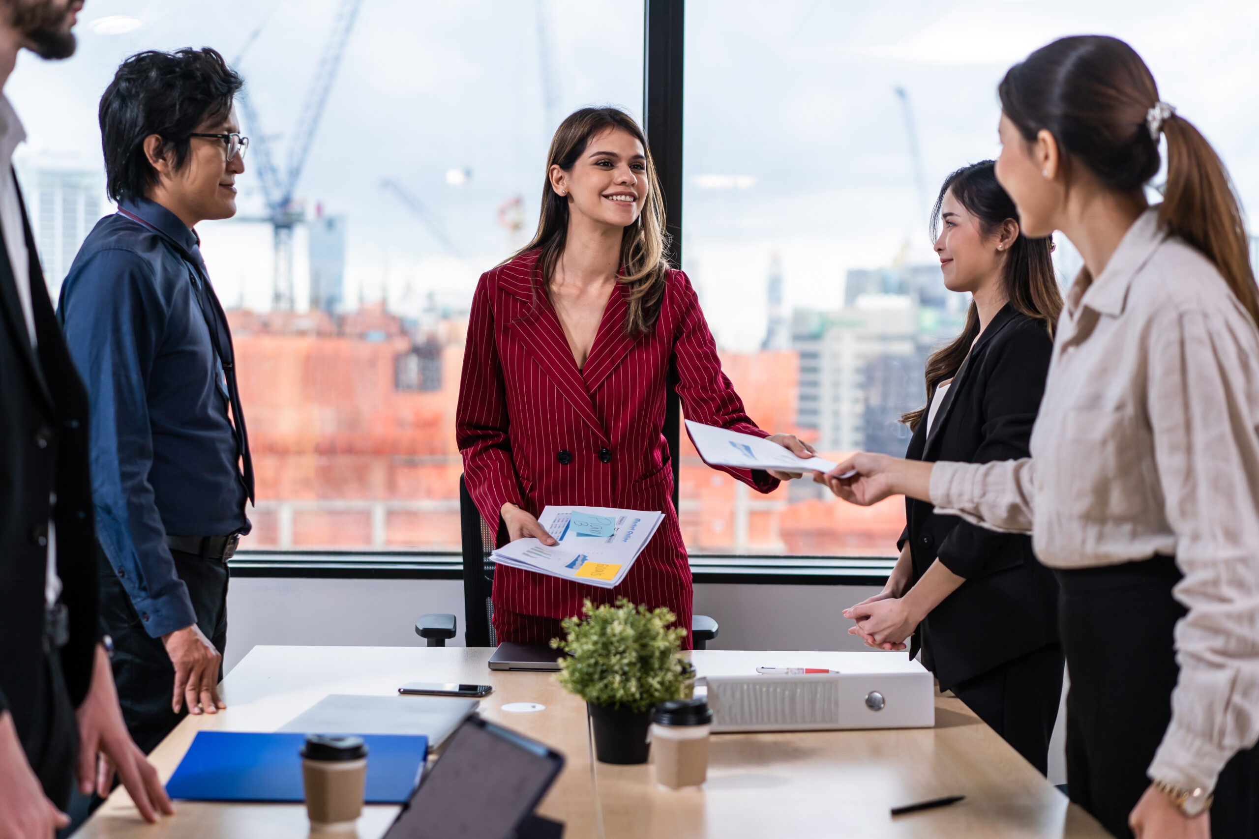 Group of multi-Ethnic businessman and businesswoman working in office. Attractive employee brainstorm and meeting as team, plan and discuss project in workplace. Corporate of modern colleagues concept