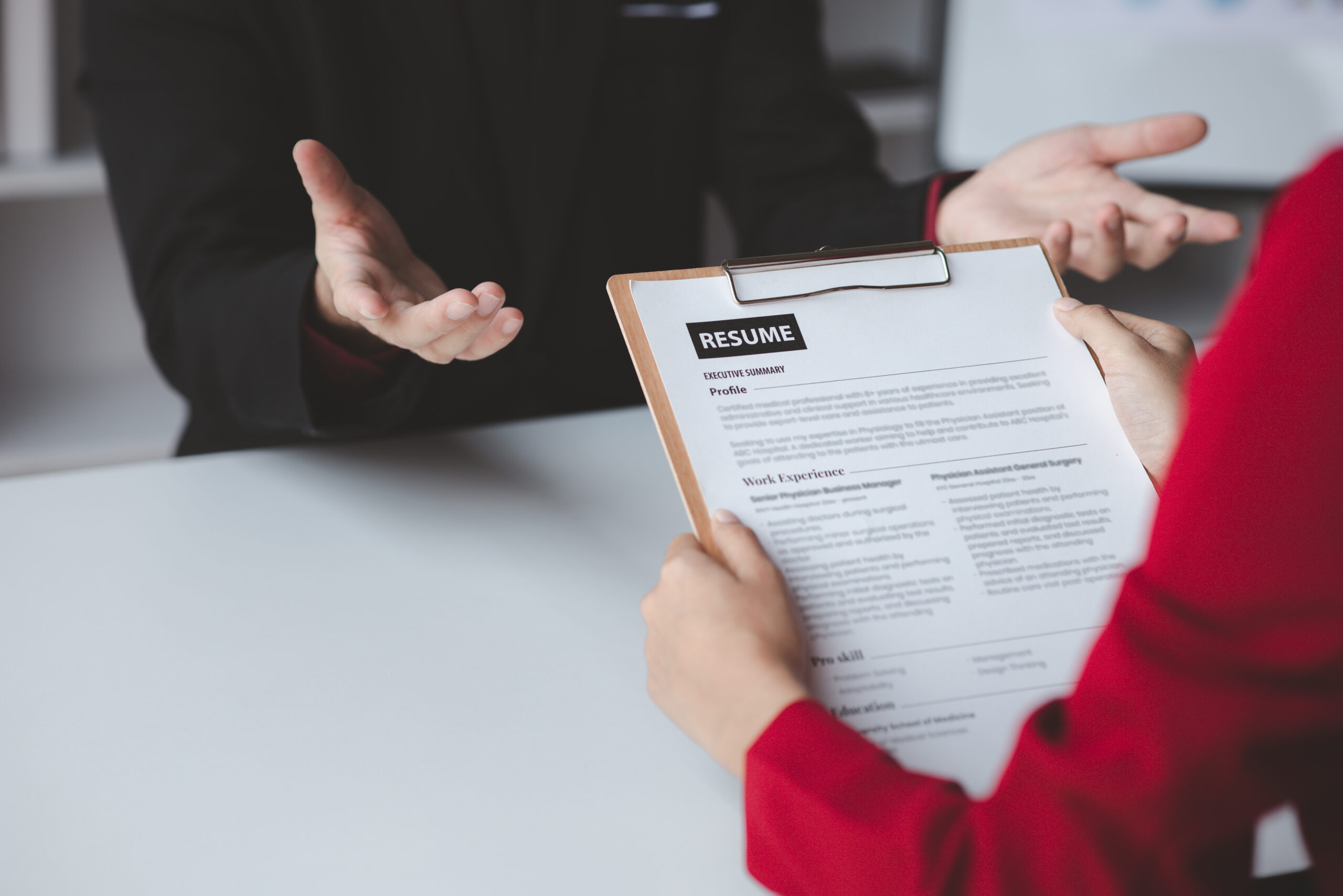Person submitting resume to interview for a job with a company, Person attending a job interview with a manager to be recruited to the company for the position applied for. Job application concept.